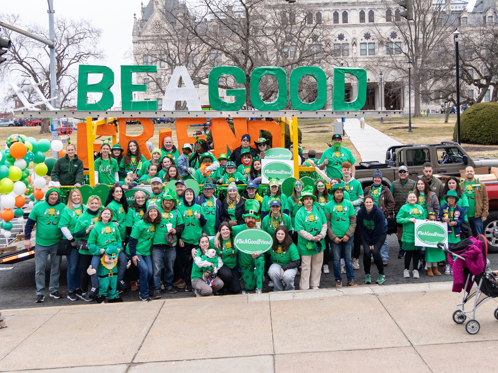 Dozens of Friends of Feeney marchers in green shirts gathered in front of the giant BE A GOOD FRIEND float at the Hartford St. Patrick’s Day Parade