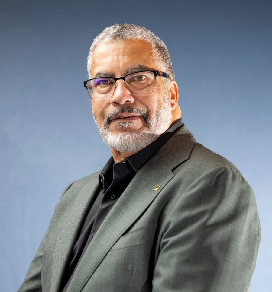Portrait of Daniel Ferreira in glasses and a green jacket