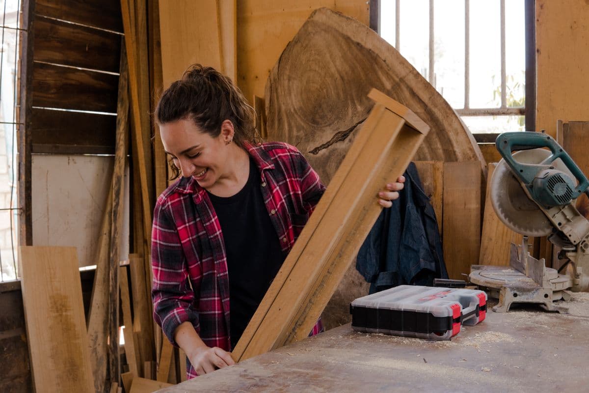 Sara Kowalski smiling as she checks a board in the shop