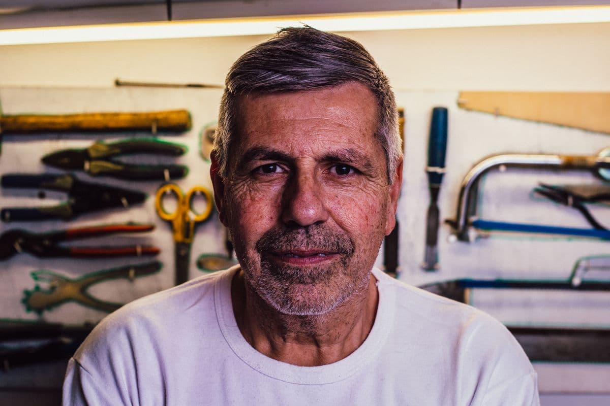 Portrait of Ray Delgado in front of a wall of hand tools